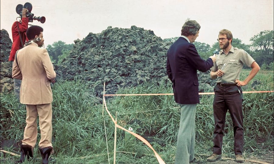 A District naturalist gives an interview to a TV station in front of the dig site.