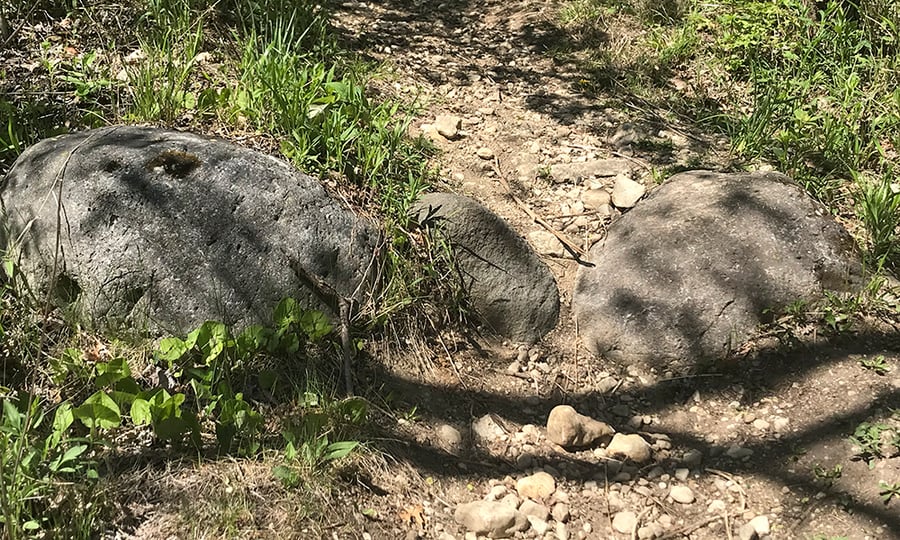 Boulders lay across a trail.