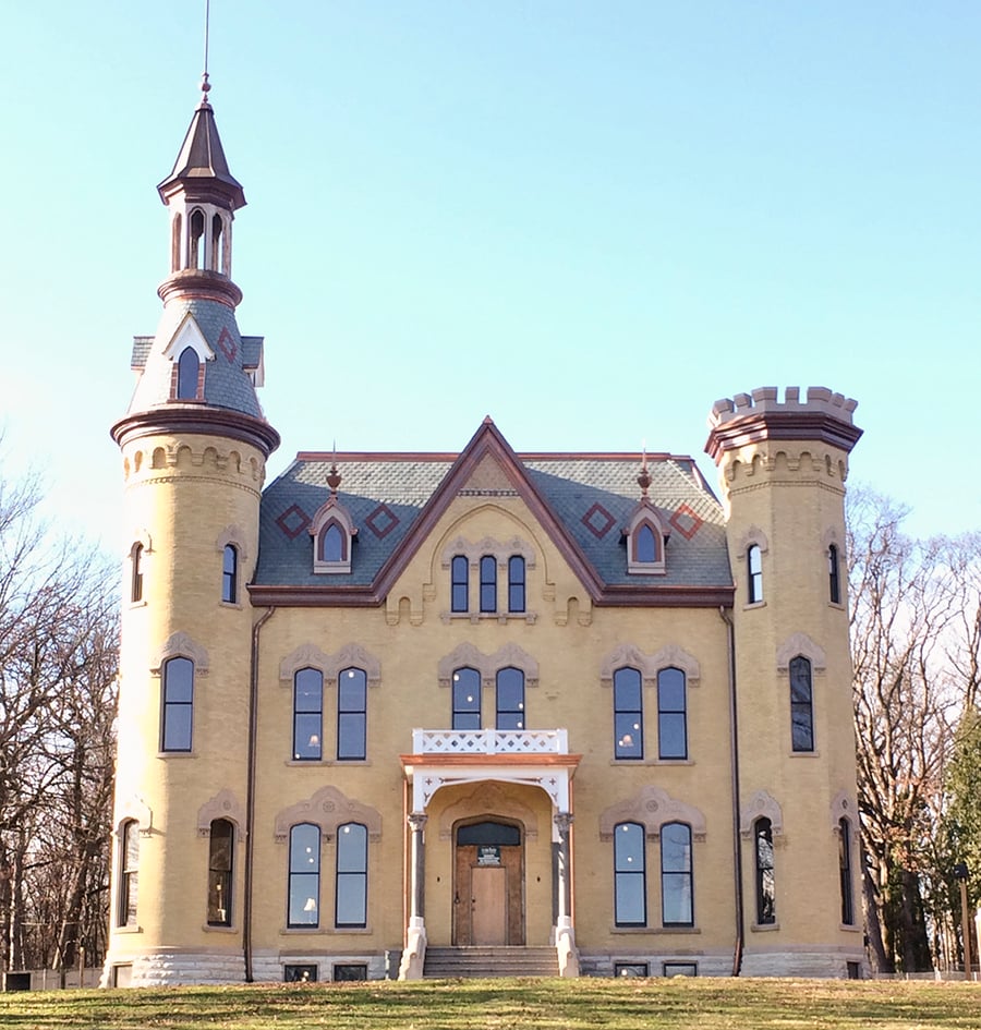 The yellow Dunham Castle is featured in a modern photograph.