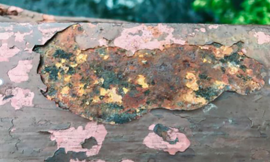 Zooming in on a patch of rust and pink paint that dots the bridge.