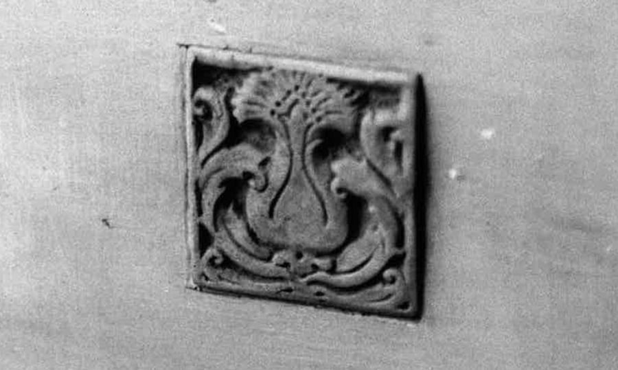 An artistic tile that was removed from a historic bench.