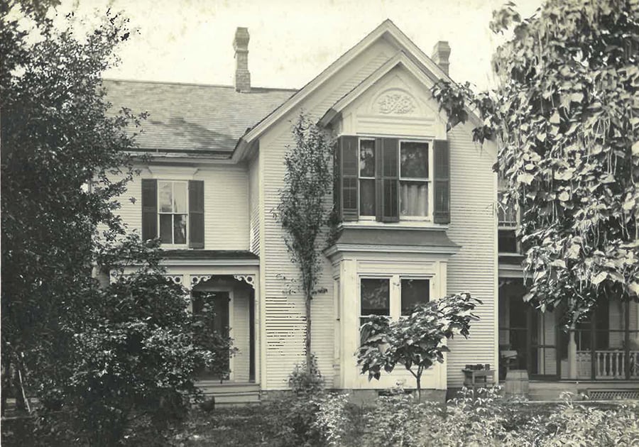 An old photo of the farmhouse shows no railing on the outdoor steps.