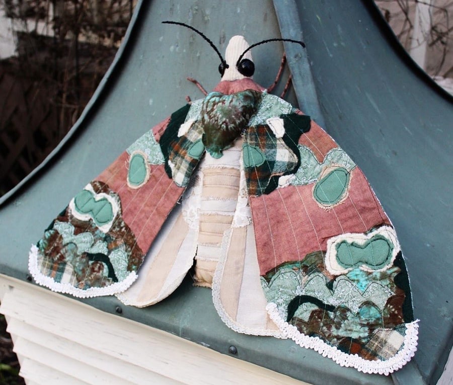 A moth made from a quilt and other cloth.