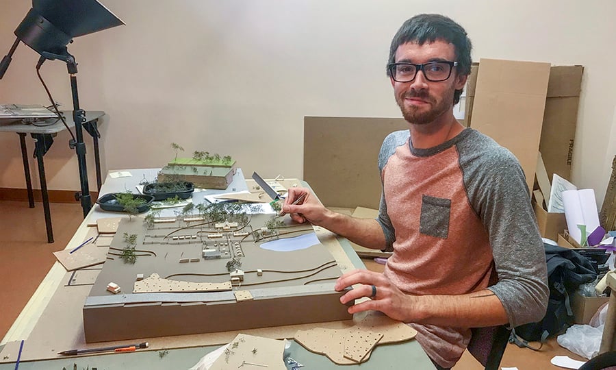 A man works on creating his model.