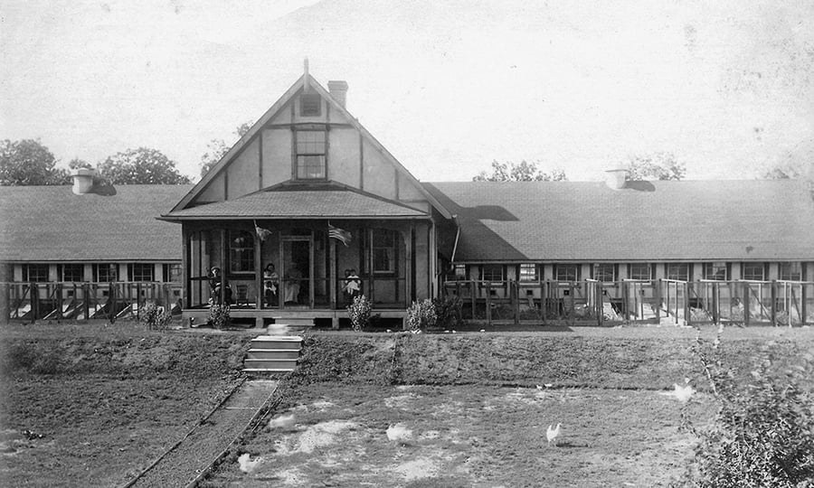 A chicken house from the 1920s is shown in this black and white photograph.