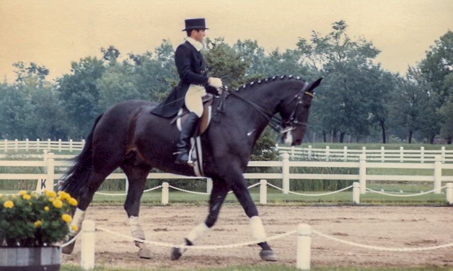 A sharp-dressed man rides a horse in this old photograph from 1985.