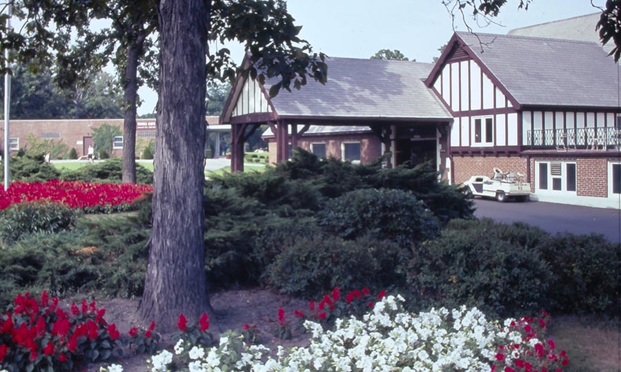 Flowers bloom outside the entrance to the Elmhurst Country Club.