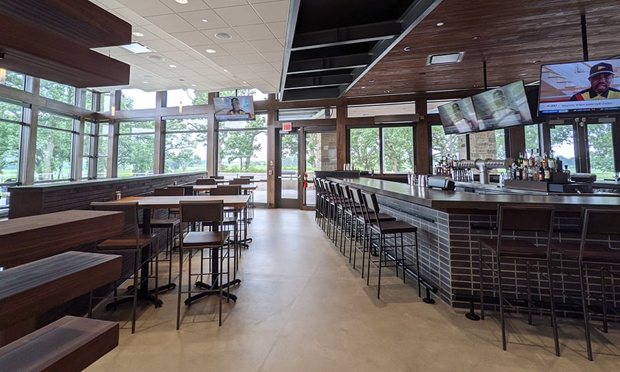 TVs hang over the bar and cocktail tables at Greenway Tap.
