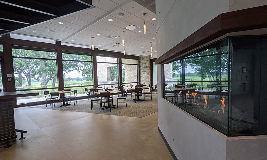Tables surround the fireplace at Greenway Tap.