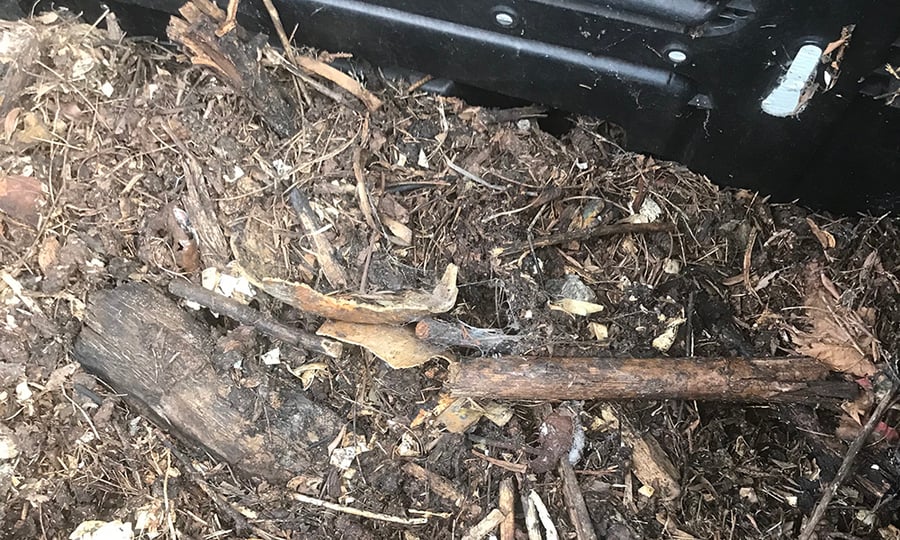 A compost pile featuring numerous organic material including sticks of myriad sizes.