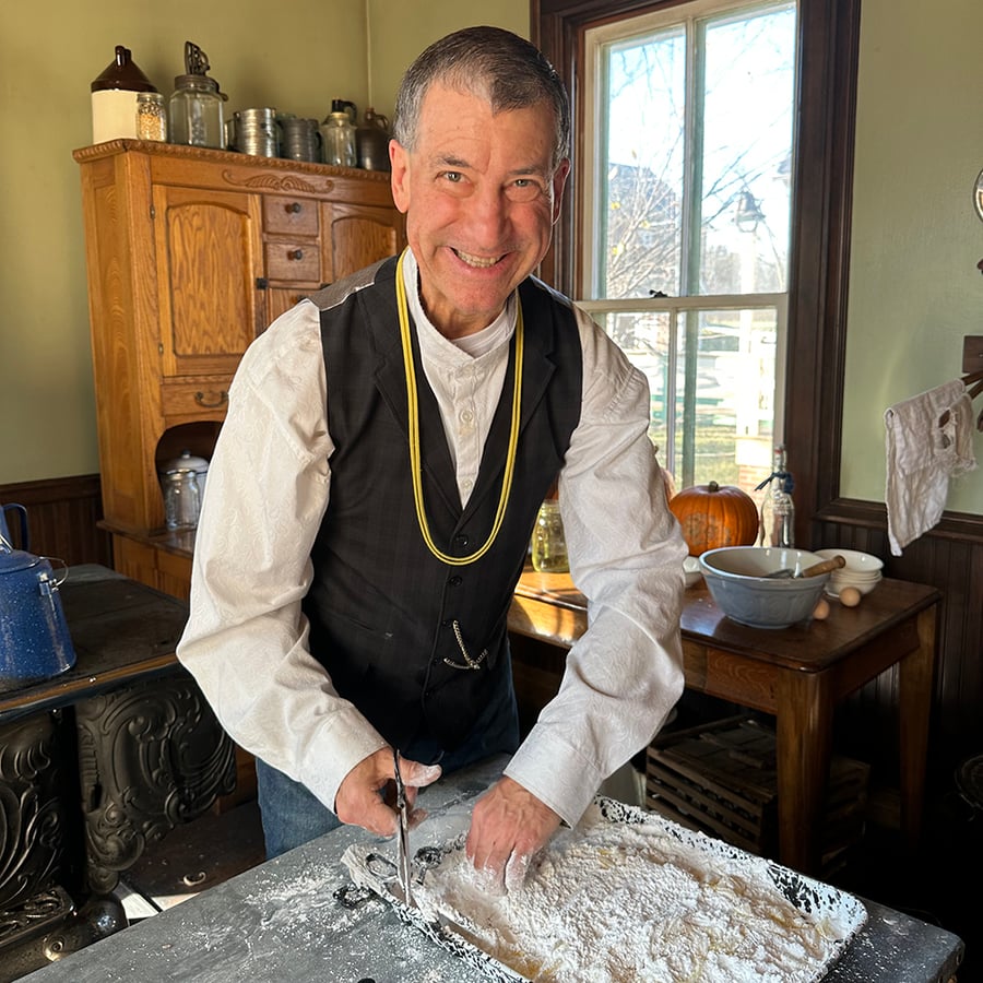 A District staff member makes candy in an old farmhouse.