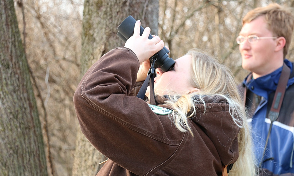 Keriann-Dubina-looks-through-binoculars