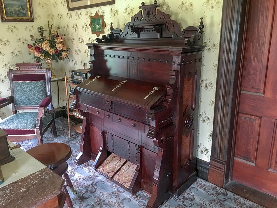 The restored pipe organ sits in the living room of the old farmhouse.