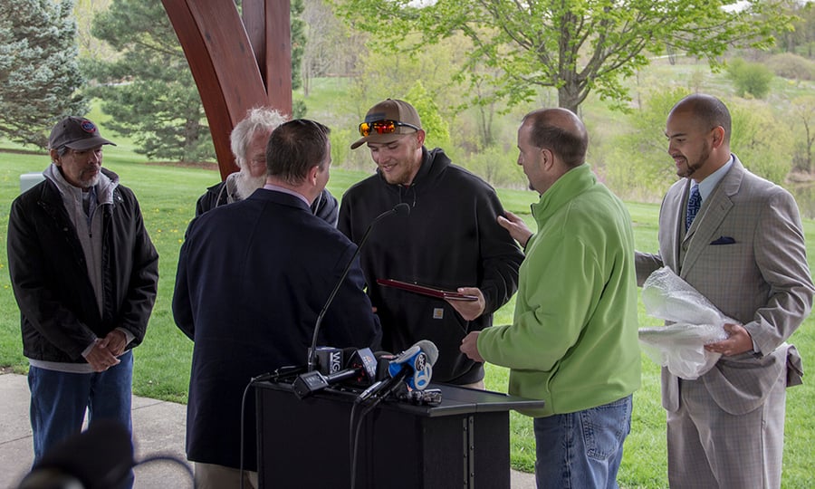 Forest Preserve District officials present the three rescuers with plaques.