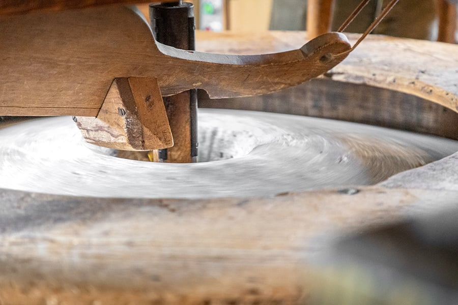 a close up of the mill's 1-ton grinding stones
