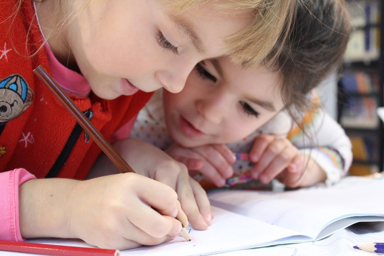 two girls working at a desk