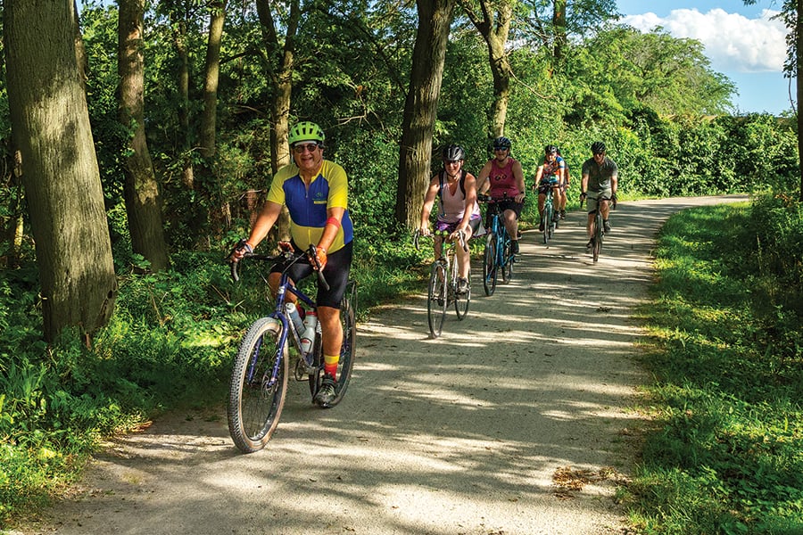 a group of people biking on a trail a group of people biking on a trail