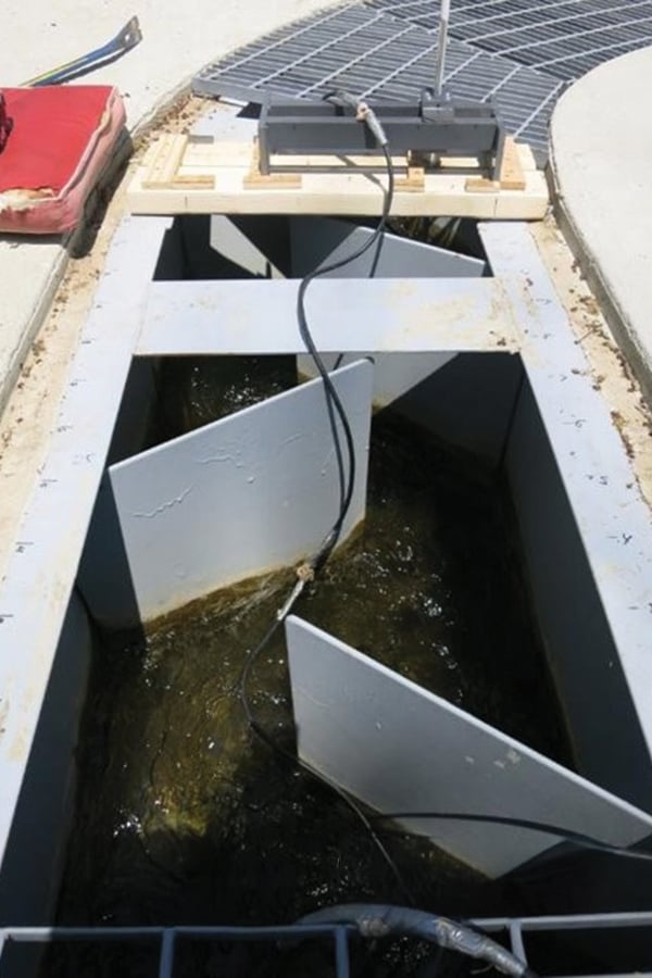 a metal chute with panels that fish use to swim upstream over a dam
